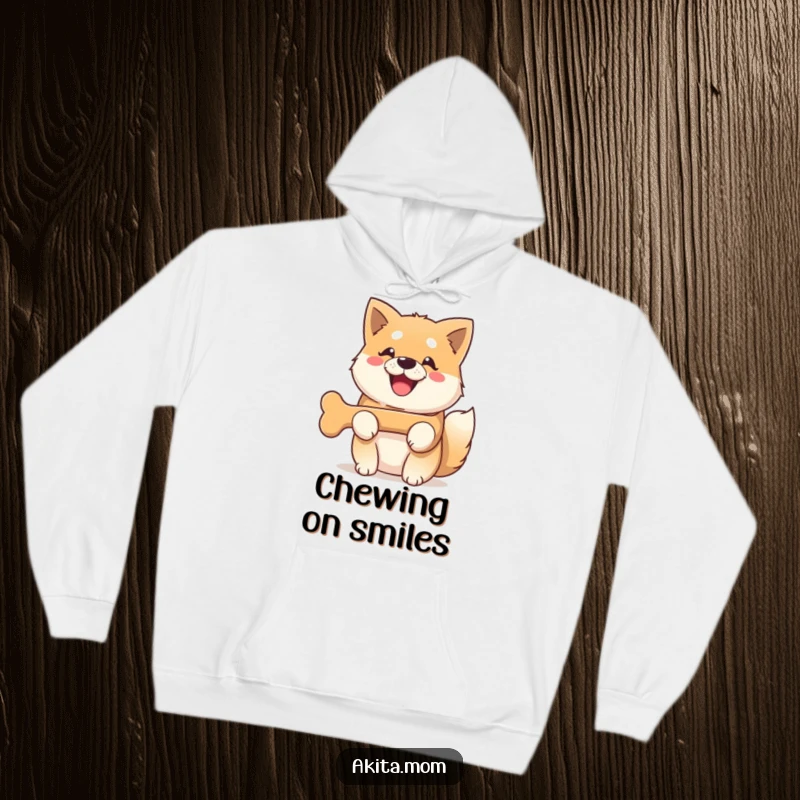 Funny Kawaii Akita dog hoodie, depicting a dog with a wide, beaming smile, happily holding a bone.