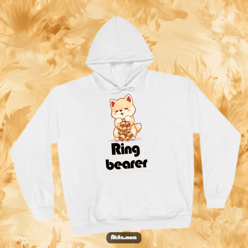 Funny Akita cub hoodie showing a playful puppy balancing a tower of tiny bells, a humorous and warm piece of apparel.