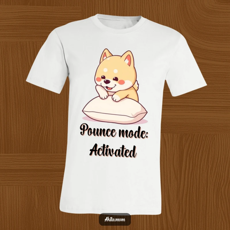 Funny Kawaii Akita t-shirt depicts a cute dog energetically pouncing onto a soft pillow, conveying pure playful delight.